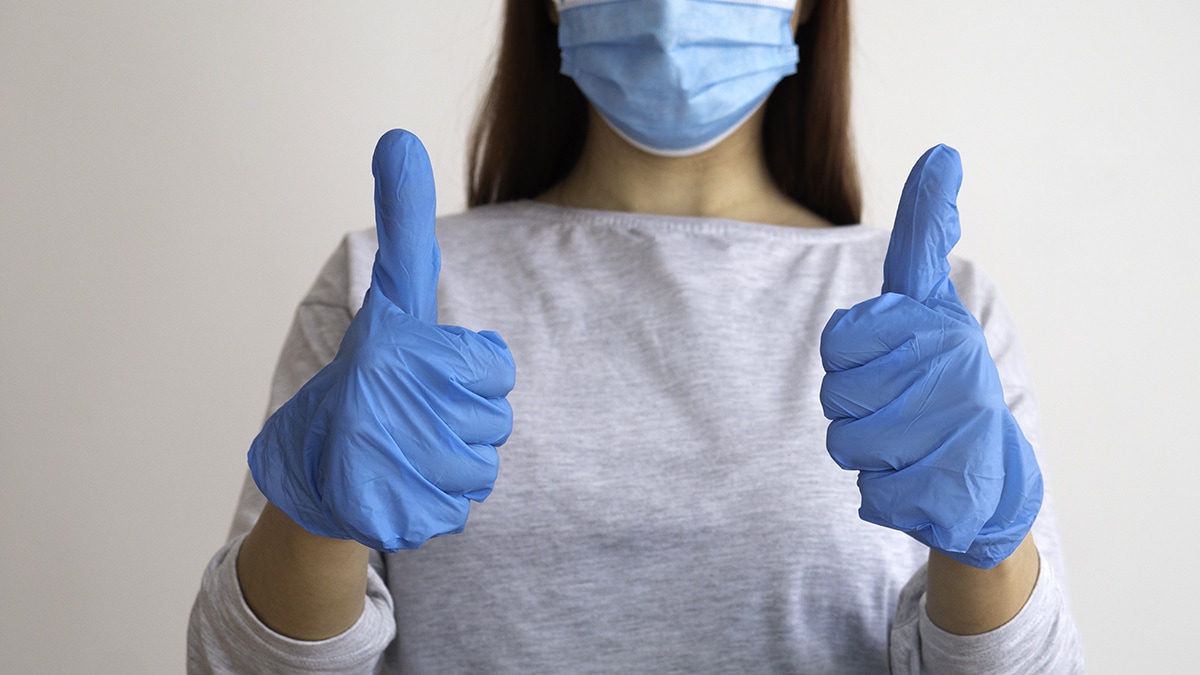 Good job medicine. A woman with gloves and a medical mask gives