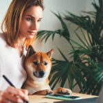 Female Artist working at home office with best friend dog,