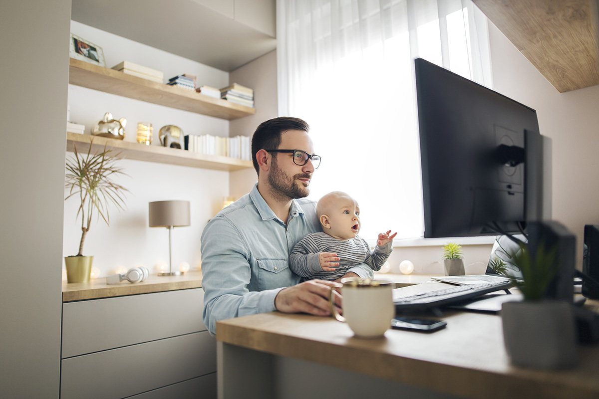 Man working with baby on lap