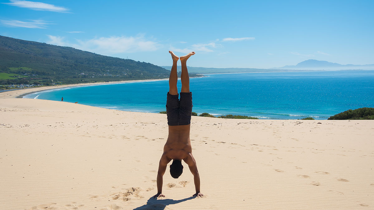 Hand stand on the sand dunes