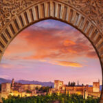 Alhambra Palace at sunset viewed throught arch