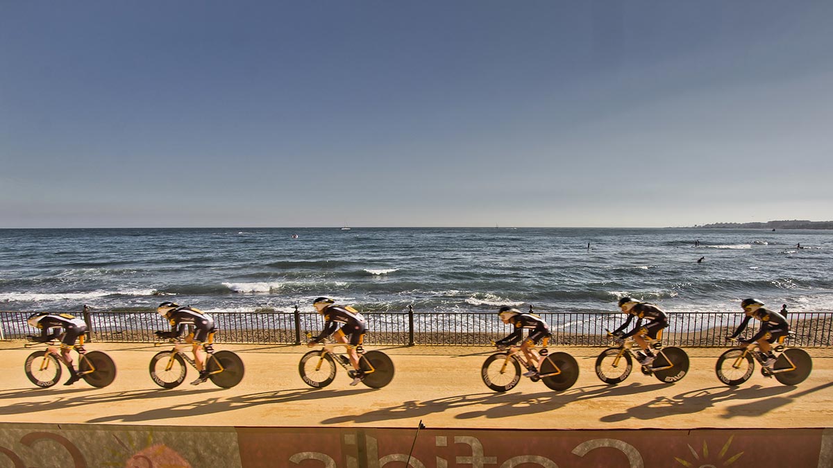 Cycling race participants whooshing by the Marbella promenade