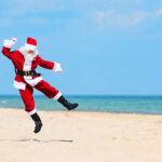 Father Christmas dancing on the beach