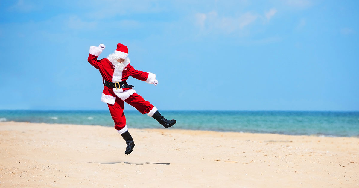 Father Christmas dancing on the beach