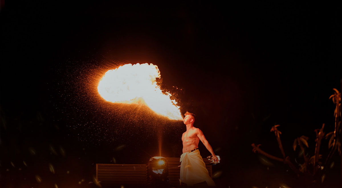 Fire eater throwing flames