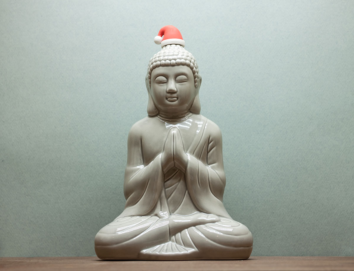 Ceramic Buddha praying with father christmas hat.