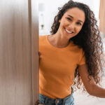 Woman opening the door with a smile