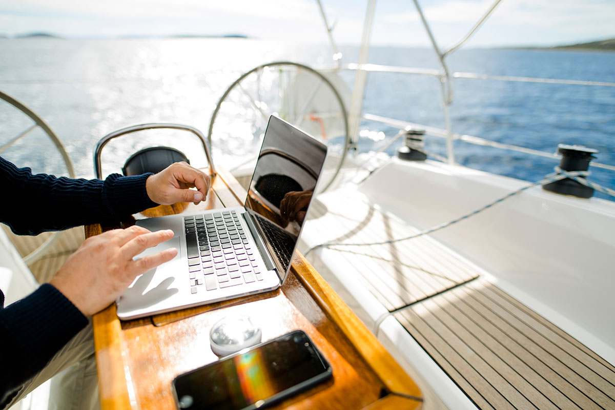 Working on laptop on a yacht.