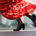 Flamenco dancer with black double strap flamenco shoes and red dress