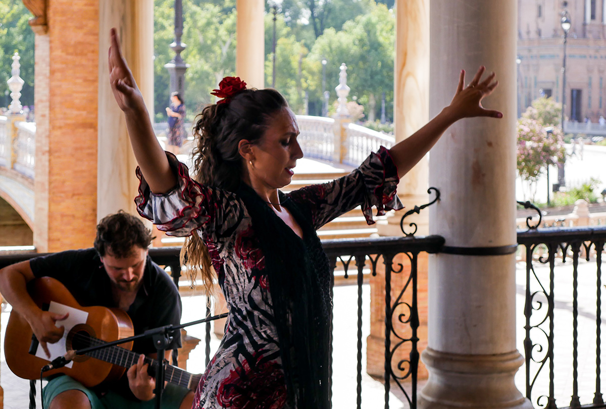 Flamenco dance accompanied by Guitarist in the Plaza de España, Seville.