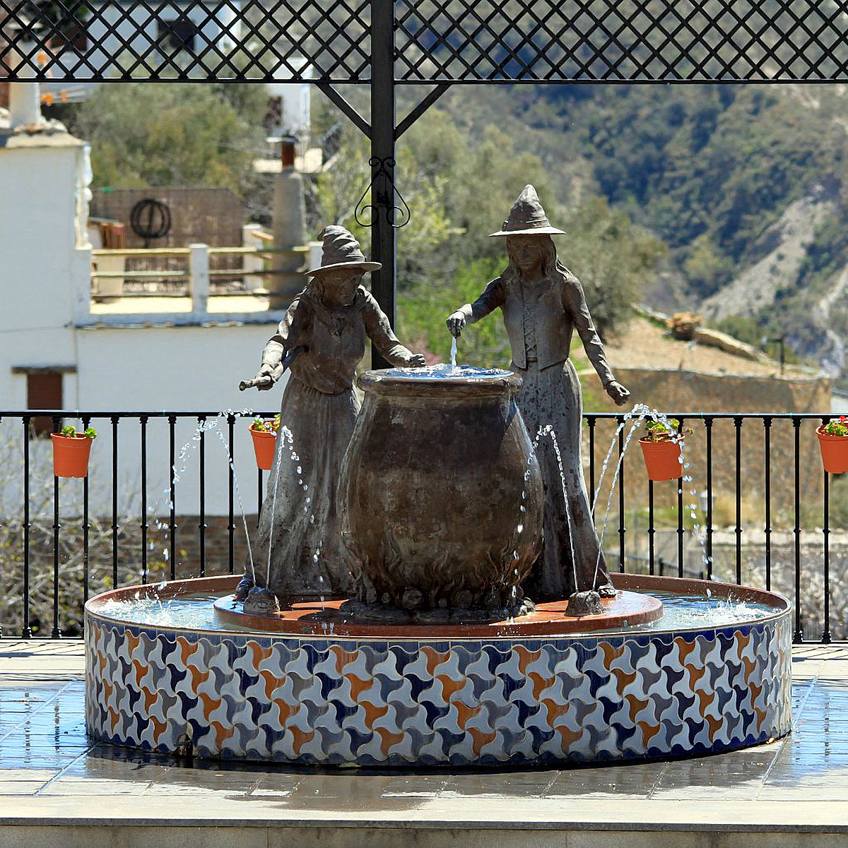 Two witches at a fountain in Soportújar