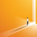Futuristic image of person walking into the light emanating between two tall yellow walls.