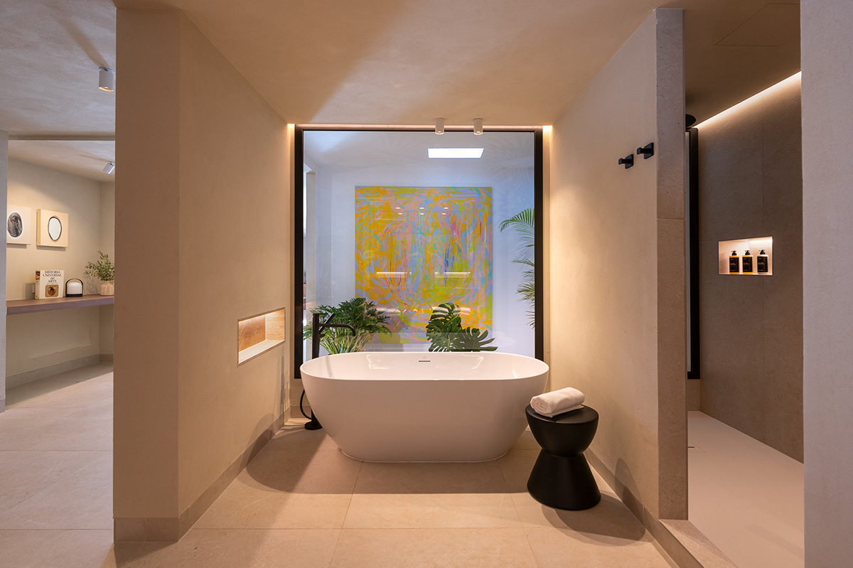 Open contemporary bathroom with free standing bath tub.