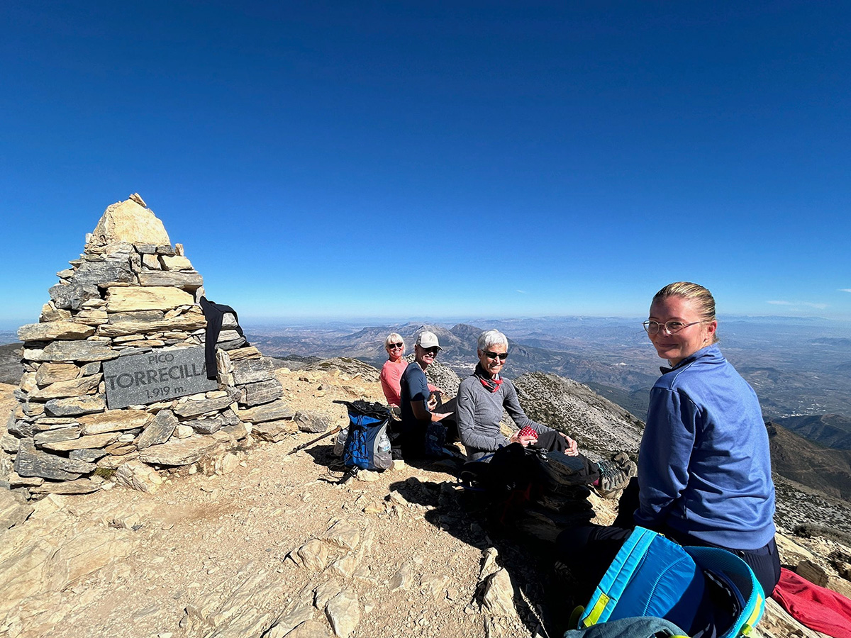 Walkers enjoying the immense views and a spot of lunch on the peak of La Torrecilla